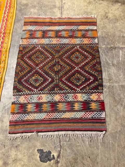 Two Kelim rugs and a geometric wool rug, largest 240 x 140cm